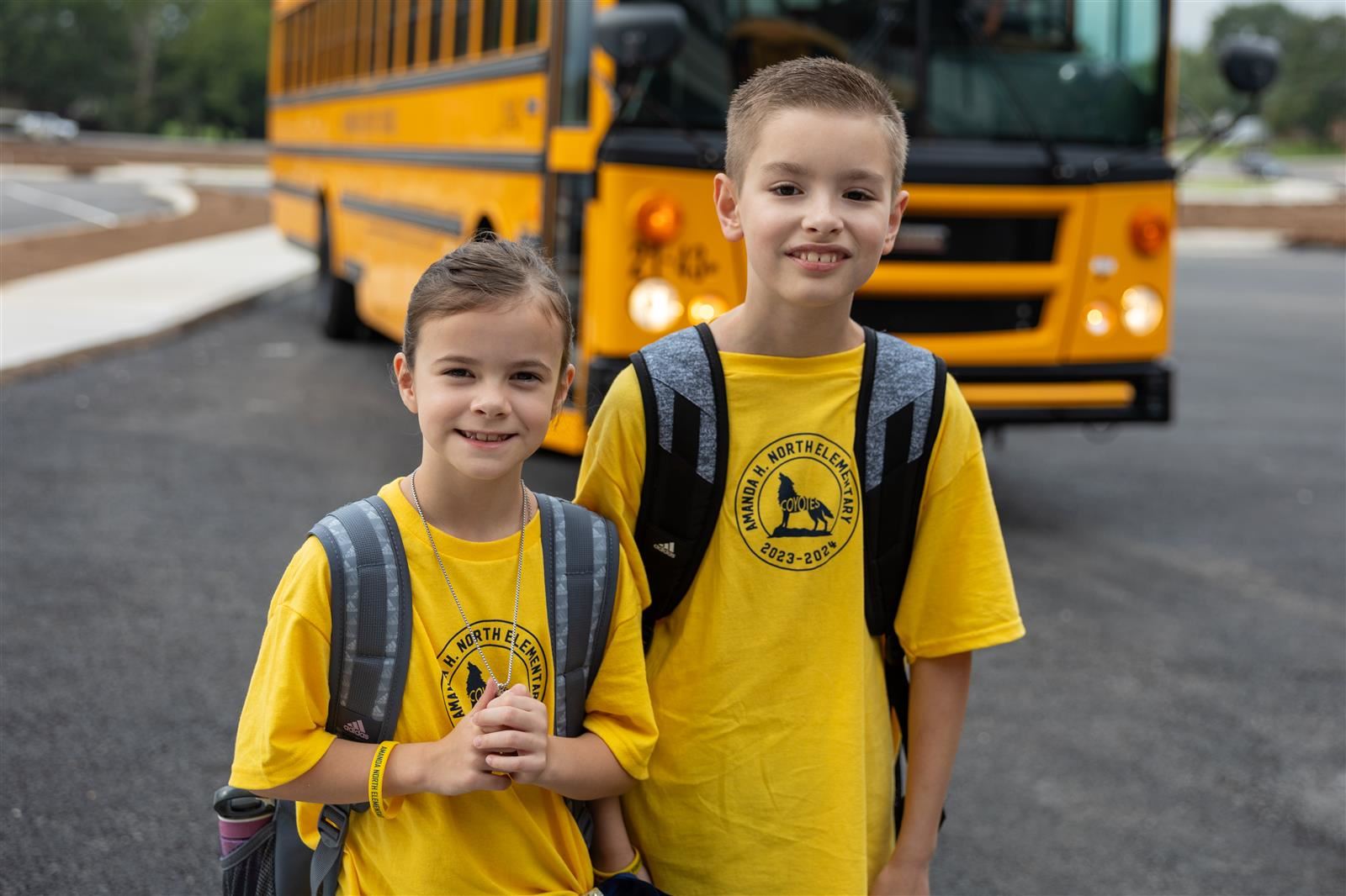 children in front of bus